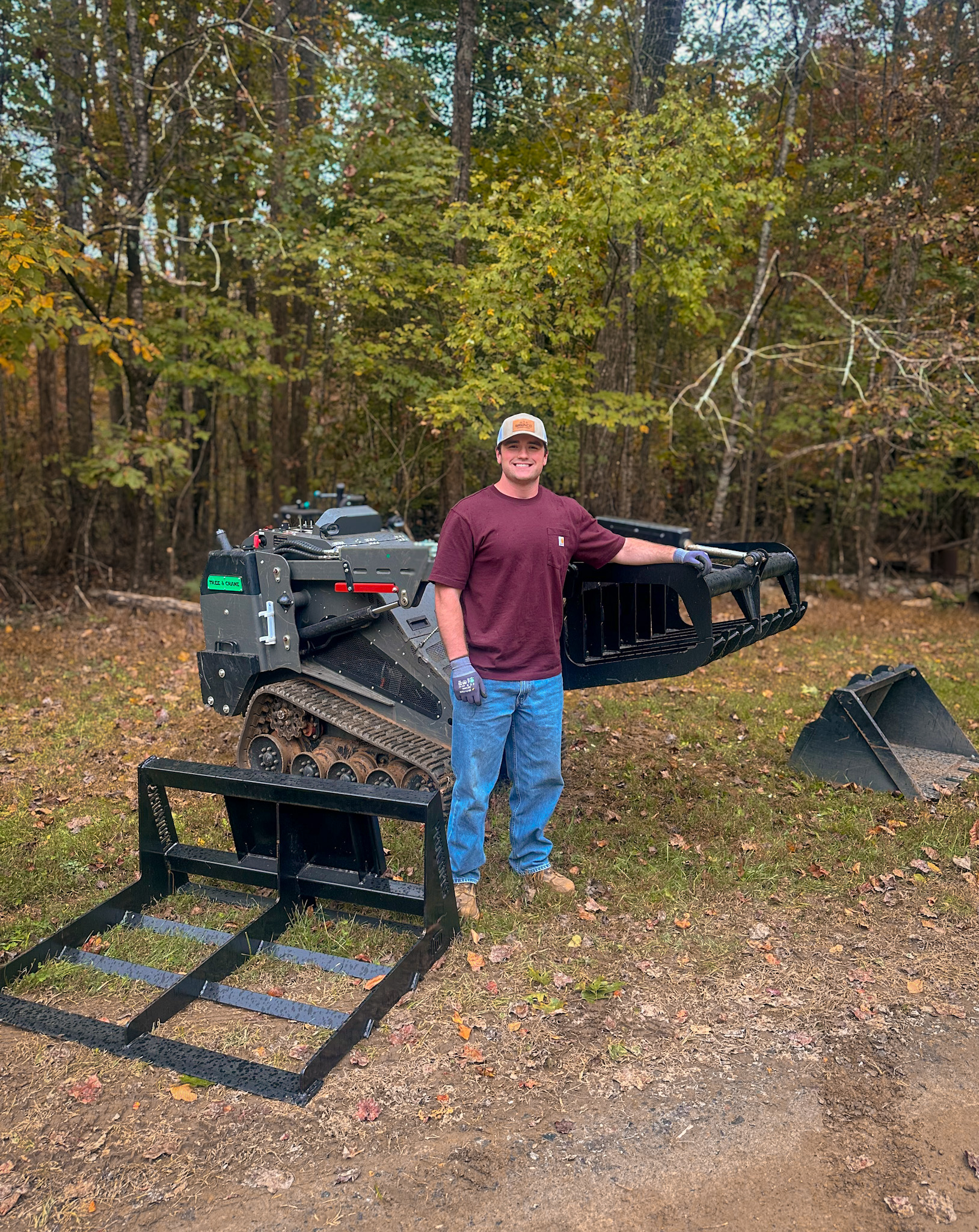 Brenco Junk Removal owner with mini skid steer and attachments in North Georgia